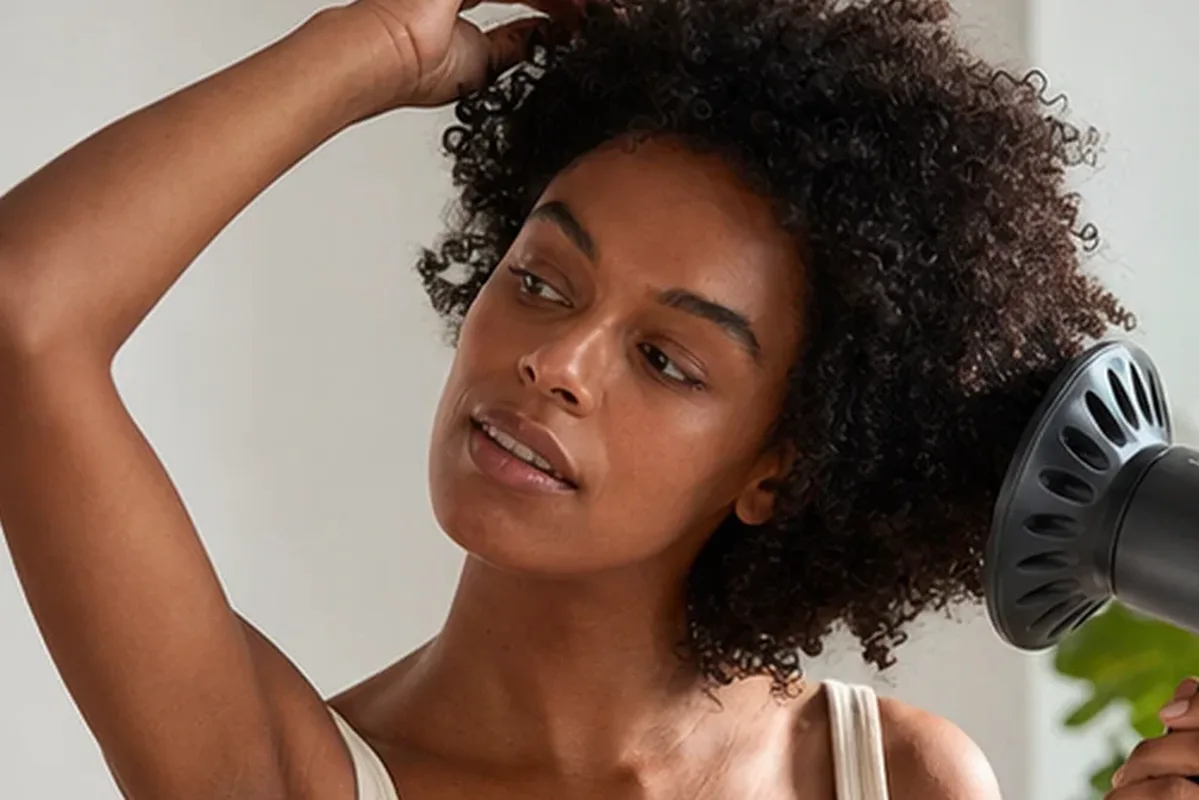 Authentischer Wohlfühlmoment passend zum Beauty-Thema Warmluftbürste für lockiges Haar